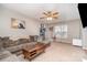 Bright living room with L-shaped sofa and ceiling fan at 844 Turning Point Ln, Concord, NC 28027