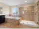 Bathroom featuring a bathtub and shower with beautiful tilework and a large window at 8509 Penton Pl, Harrisburg, NC 28075