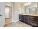 Bright bathroom with marble countertops, a modern vanity, and ceramic tile flooring at 8509 Penton Pl, Harrisburg, NC 28075