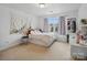 Cozy bedroom featuring a bed with storage, a window, and a decorative wall tapestry at 8509 Penton Pl, Harrisburg, NC 28075