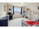 Bright bedroom featuring a desk, bookshelf, and comfortable bed with decorative pillows at 8509 Penton Pl, Harrisburg, NC 28075