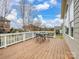 Spacious deck with wood flooring, white railing, and a table with seating at 8509 Penton Pl, Harrisburg, NC 28075