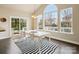 Dining area with large windows, a sliding door, and a modern white table at 8509 Penton Pl, Harrisburg, NC 28075