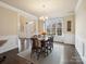 Formal dining room with hardwood floors, wainscoting, a large window, and entry to the foyer at 8509 Penton Pl, Harrisburg, NC 28075