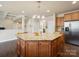 Large kitchen island with granite countertop and cabinet space at 8509 Penton Pl, Harrisburg, NC 28075