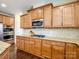 Well-equipped kitchen featuring granite countertops, wooden cabinets, and stainless steel appliances at 8509 Penton Pl, Harrisburg, NC 28075