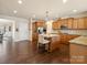 Bright kitchen featuring an eat-in island, stainless steel appliances, and wood cabinetry at 8509 Penton Pl, Harrisburg, NC 28075