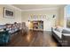 Well-lit living room with hardwood floors, neutral paint, built-in bookshelves, and a cozy reading nook at 8509 Penton Pl, Harrisburg, NC 28075