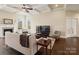 Well-lit living room with hardwood floors, coffered ceilings, a fireplace, and an entertainment setup at 8509 Penton Pl, Harrisburg, NC 28075