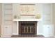 Living room fireplace with built-in shelving and a neutral color scheme at 9041 J M Keynes Dr # 10, Charlotte, NC 28262