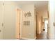 A light and airy hallway with tile flooring and access to other rooms at 9041 J M Keynes Dr # 10, Charlotte, NC 28262