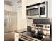 Stainless steel appliances and dark countertops in a modern kitchen at 9041 J M Keynes Dr # 10, Charlotte, NC 28262