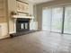 Spacious living room with tile floors, fireplace and sliding glass doors at 9041 J M Keynes Dr # 10, Charlotte, NC 28262