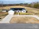 Aerial view of home with solar panels, long driveway and large surrounding lawn at 9489 Westridge Dr, Hickory, NC 28601