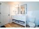 Contemporary bathroom with a double vanity, storage, and white tile; perfect for modern living at 9489 Westridge Dr, Hickory, NC 28601