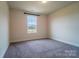 Bedroom featuring neutral walls, carpeting, and a window overlooking the landscape at 9489 Westridge Dr, Hickory, NC 28601