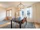 Elegant dining room with modern lighting, hardwood floors, and large windows at 9489 Westridge Dr, Hickory, NC 28601