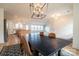 Dining area showcasing a modern chandelier and open layout leading to a bright kitchen at 9489 Westridge Dr, Hickory, NC 28601