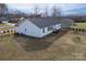 Rear view of home showcasing large yard, mature trees, and back deck at 9489 Westridge Dr, Hickory, NC 28601