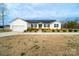 Lovely front exterior view of the home with solar panels and a driveway at 9489 Westridge Dr, Hickory, NC 28601