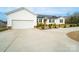 Home featuring a two-car garage, large driveway, and well-maintained landscaping at 9489 Westridge Dr, Hickory, NC 28601