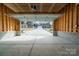 Spacious two car garage interior with concrete floors, open overhead door to the driveway and neighborhood beyond at 9489 Westridge Dr, Hickory, NC 28601