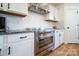 Modern kitchen with stainless steel appliances, white cabinetry, subway tile backsplash, and granite countertops at 9489 Westridge Dr, Hickory, NC 28601