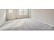 Spacious bedroom with neutral carpeting and ample natural light at 9859 Old Garden Cir, Gastonia, NC 28056