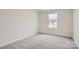 Simple bedroom with neutral walls and carpet at 9859 Old Garden Cir, Gastonia, NC 28056