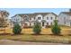 Three-unit townhome building, showcasing attractive brick and siding exteriors at 9859 Old Garden Cir, Gastonia, NC 28056