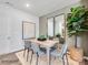 Dining room with wood table, gray chairs, and large plant at 9863 Old Garden Cir, Gastonia, NC 28056