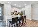 White kitchen with island, quartz countertops, and hardwood floors at 9863 Old Garden Cir, Gastonia, NC 28056