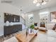 Living room with neutral furniture, wood coffee table, and large TV at 9863 Old Garden Cir, Gastonia, NC 28056