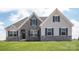 Two-story house with stone accents and gray siding at Lot 1 Glenview Meadow Dr # Arcadia, Waxhaw, NC 28173