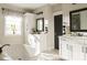 Bright bathroom with white cabinets, dual vanities, and a free-standing tub at Lot 1 Glenview Meadow Dr # Notthingham, Waxhaw, NC 28173