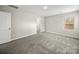 Bedroom with grey carpet, window, and door to bath at 107 Fosters Glen Pl, Mooresville, NC 28115