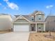 Two-story house with gray and green siding, white garage door, and landscaping at 107 Fosters Glen Pl, Mooresville, NC 28115