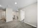 Upstairs hallway with carpet and doors to bedrooms at 107 Fosters Glen Pl, Mooresville, NC 28115