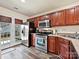 Modern kitchen with stainless steel appliances and wood cabinets at 11023 Alderbrook Ln, Charlotte, NC 28270