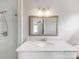 Bathroom featuring a glass enclosed shower and vanity with marble countertop and a decorative mirror at 1116 Circlewood Dr, Charlotte, NC 28211