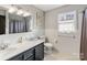 Well-lit bathroom with double sink vanity, tile accents, framed mirror, and a window for a refreshing feel at 1116 Circlewood Dr, Charlotte, NC 28211