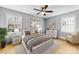 Cozy bedroom featuring a ceiling fan, light grey walls, natural light, and wood floors at 1116 Circlewood Dr, Charlotte, NC 28211