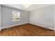 Bedroom with light walls, hardwood floors, and a large window offering natural light at 1116 Circlewood Dr, Charlotte, NC 28211