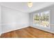 Inviting bedroom filled with natural light from the big window and classic hardwood floors at 1116 Circlewood Dr, Charlotte, NC 28211