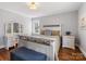 Bedroom with a white wooden framed bed and a matching vanity and drawers with wooden floors at 1116 Circlewood Dr, Charlotte, NC 28211