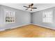 Bright, light-filled bedroom with hardwood floors and two large windows for ample sunlight at 1116 Circlewood Dr, Charlotte, NC 28211