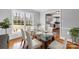 Sunlit dining area adjacent to kitchen has a glass table and hardwood floors at 1116 Circlewood Dr, Charlotte, NC 28211