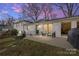 Exterior patio with seating and a grill at dusk at 1116 Circlewood Dr, Charlotte, NC 28211