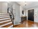 Inviting foyer features hardwood floors, a staircase with iron railings, and a stylish console table at 1116 Circlewood Dr, Charlotte, NC 28211