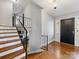Inviting foyer features hardwood floors, a staircase with iron railings, and a stylish console table at 1116 Circlewood Dr, Charlotte, NC 28211